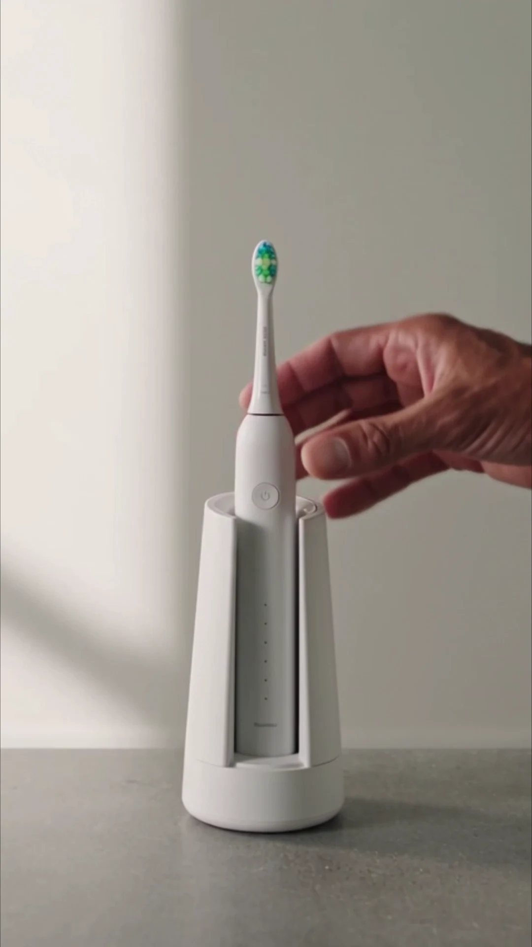 White sonic toothbrush in a sanitizing dock