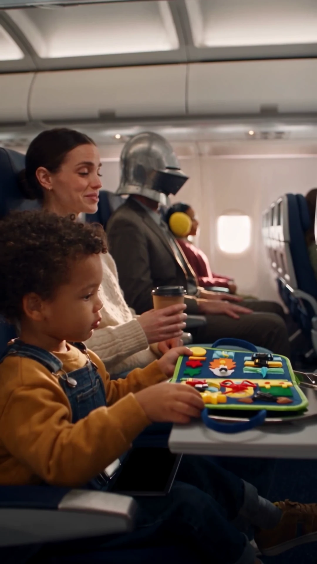 Child using a travel busy board on a flight